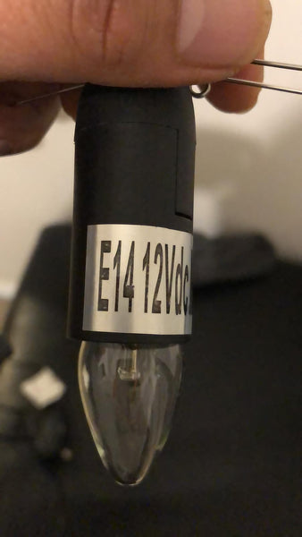 Close-up of a replacement power cord with a label