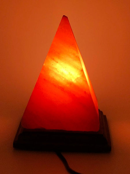 Pyramid Shaped Himalayan Salt Lamp glowing on a premium wooden base handcrafted from authentic Himalayan pink rock salt by Crystal Mines Australia,